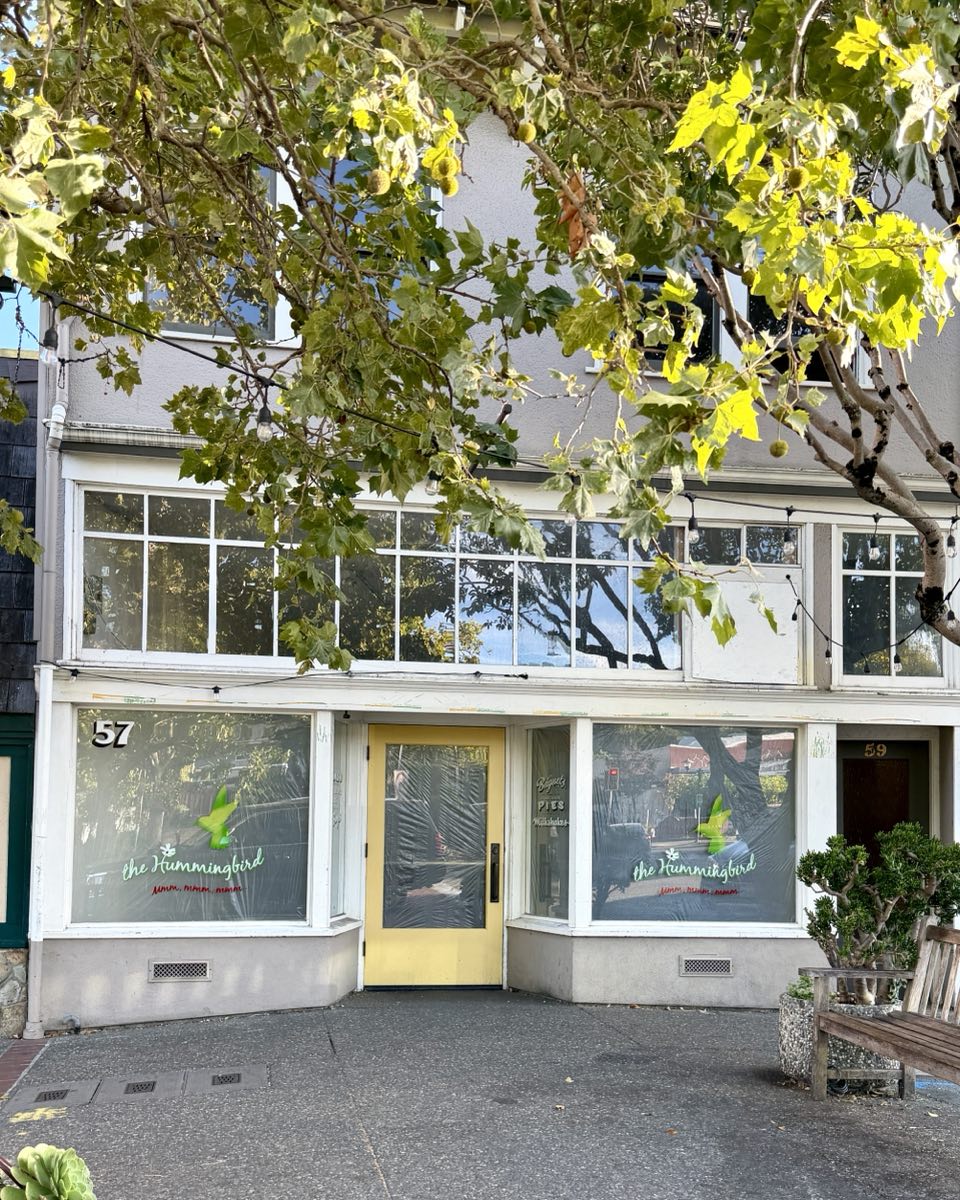 The recently closed Hummingbird cafe on Broadway, its windows papered over from the inside.